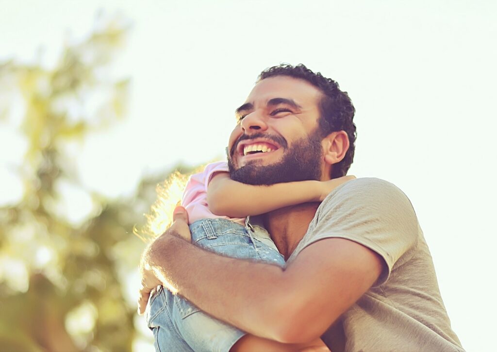 Dad hugging his daughter - good fathers are men who WANT to be dads