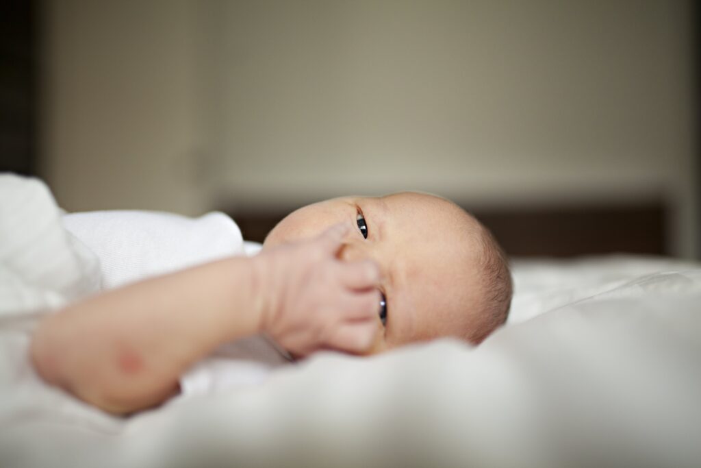 Why Does My Baby Spit Up When Laid Down? [8 WAYS TO PREVENT IT]