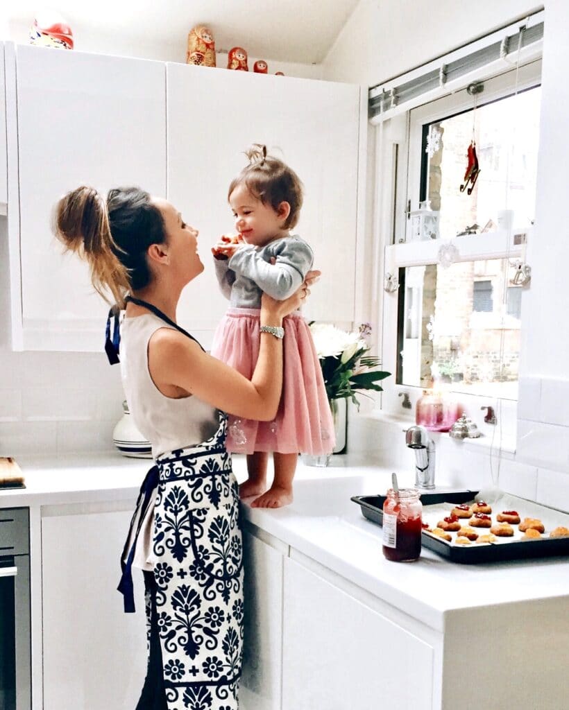 Toddler and mom in kitchen cooking and playing together