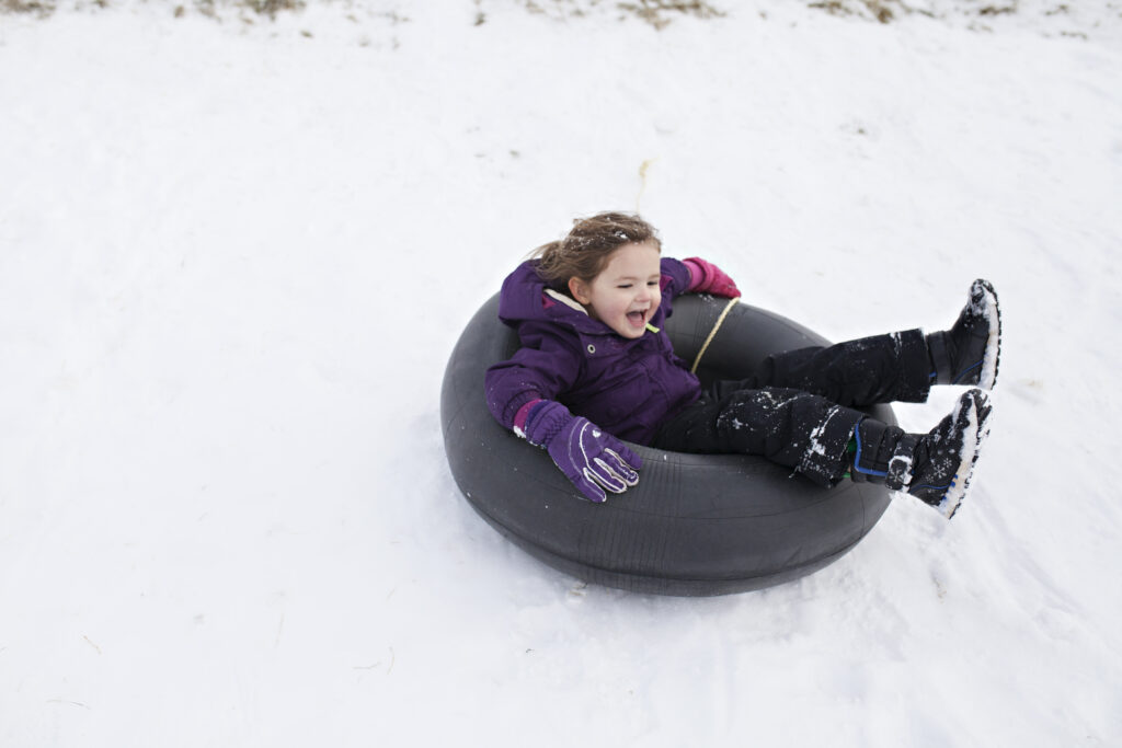 kids-playing-in-the-snow-wearing-full-snow-gear-and-sledding-down-hills-boys-sledding-fast-down-hills - Classic Two Syllable Girl Names