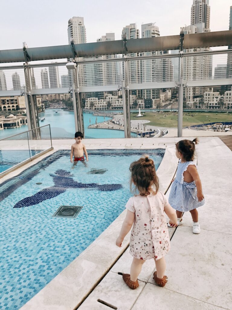 two baby girls by a pool