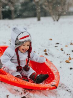 baby playing in snow