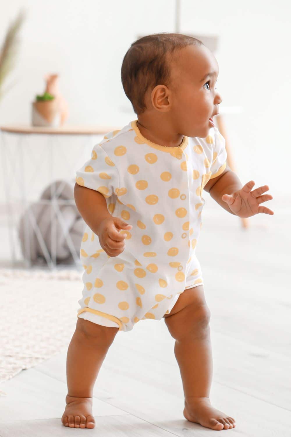baby taking his first steps at home