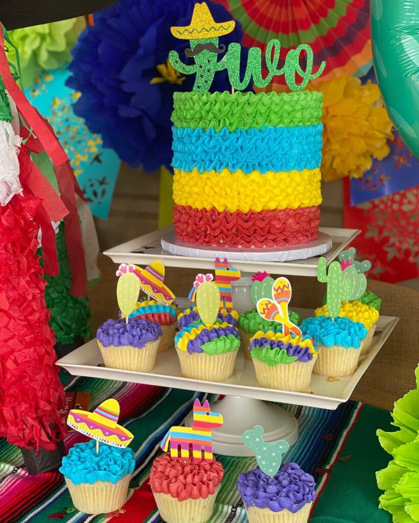 Taco fiesta-inspired tall birthday cake and cupcakes