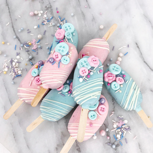 Cakesicle Reveal: Assorted cakesicles with pink and blue centers.