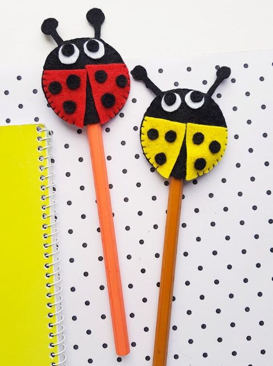 DIY felt ladybug pencil toppers in yellow and red colors