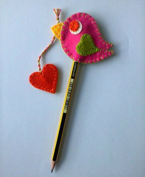 Pink colored DIY felt owl pencil toppers with a heart in its beak