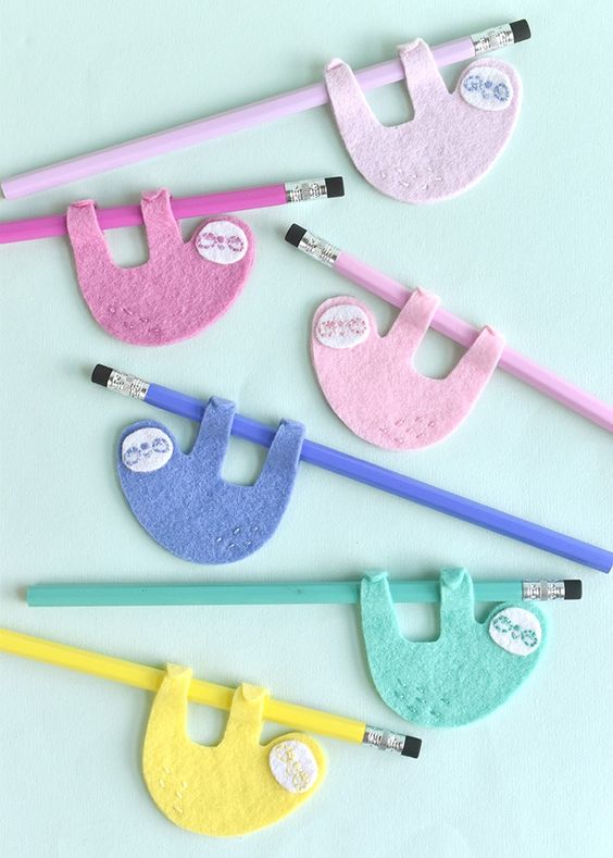 DIY sloth pencil toppers in different pastel colors