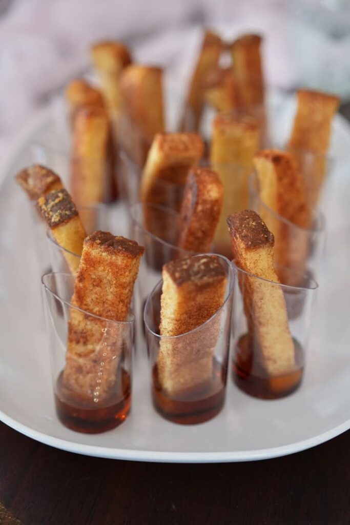 French toast sticks served with syrup in mini cups for a baby shower brunch.