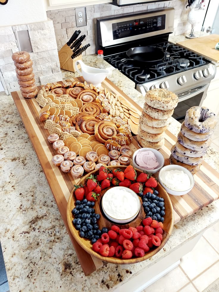 A selection of donuts, pastries, and fresh berries with yogurt for a baby shower brunch.