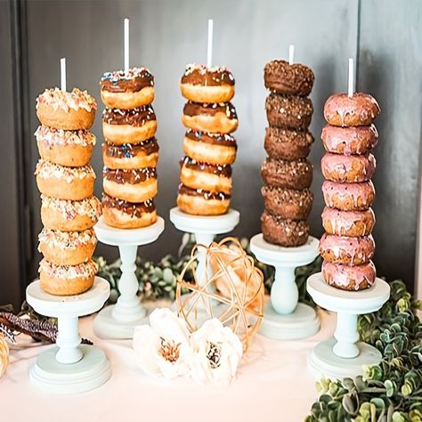 A display of donuts on sticks with colorful toppings for a baby shower brunch.